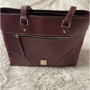Brand New without tags Dooney & Bourke Purse, The Color is a deep wine.